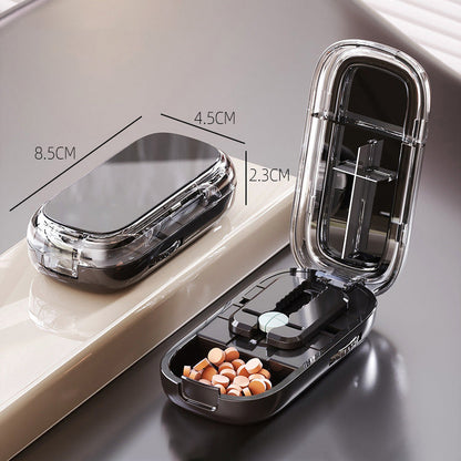 Portable pill organizer with cutter