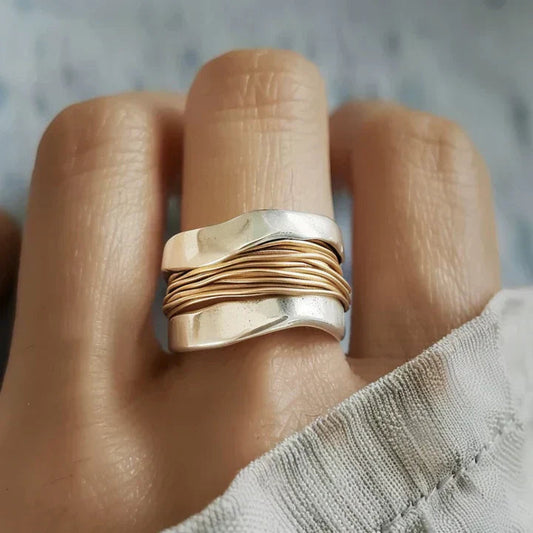 Graceful silver ring featuring subtle golden highlights