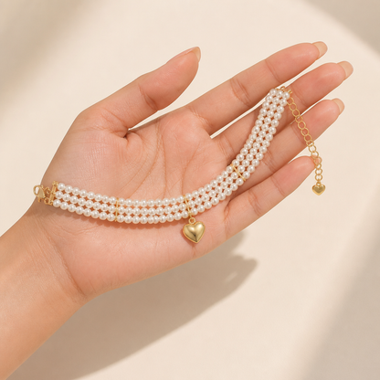 LumaLuxe™ – Elegant Triple-Strand Pearl Necklace with Gold Heart Charm