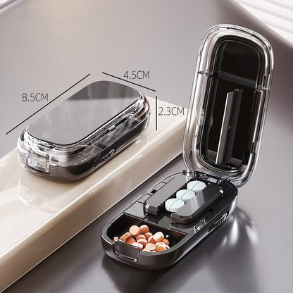 Portable pill organizer with cutter
