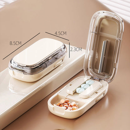Portable pill organizer with cutter